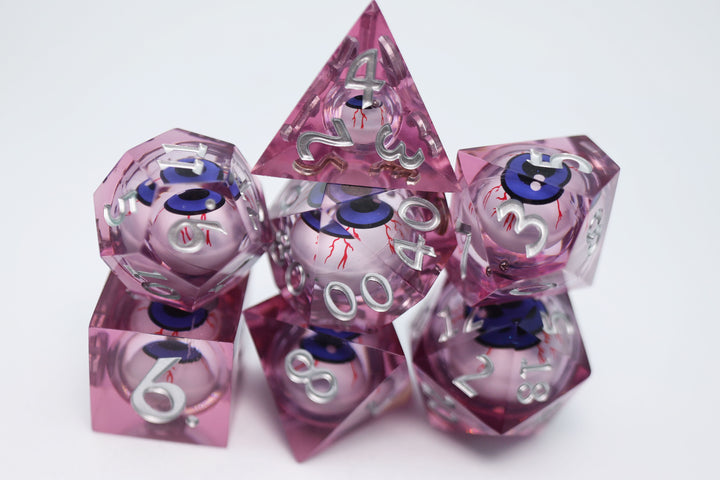 Sharp Edge Moving Eye RPG Dice Set - Bloodshot These super sharp edge dice are hand polished instead of tumbled to give them the shine without softening their edges. These dice are unique and each die in the set has a moving eye that's always looking up!  Perfect for Role Playing Games like Dungeons and Dragons (D&D), Shadowrun, Pathfinder, Warhammer, fantasy, sci-fi, or party games.   Details:  Set Type: 7 Piece RPG Set (D4, D6, D8, D10, D1%, D12, D20) Size: 16mm Material: Resin Color: Pink