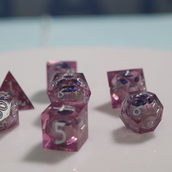 Sharp Edge Moving Eye RPG Dice Set - Bloodshot These super sharp edge dice are hand polished instead of tumbled to give them the shine without softening their edges. These dice are unique and each die in the set has a moving eye that's always looking up!  Perfect for Role Playing Games like Dungeons and Dragons (D&D), Shadowrun, Pathfinder, Warhammer, fantasy, sci-fi, or party games.   Details:  Set Type: 7 Piece RPG Set (D4, D6, D8, D10, D1%, D12, D20) Size: 16mm Material: Resin Color: Pink