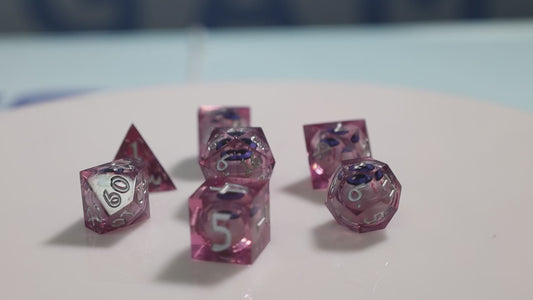 Sharp Edge Moving Eye RPG Dice Set - Bloodshot These super sharp edge dice are hand polished instead of tumbled to give them the shine without softening their edges. These dice are unique and each die in the set has a moving eye that's always looking up!  Perfect for Role Playing Games like Dungeons and Dragons (D&D), Shadowrun, Pathfinder, Warhammer, fantasy, sci-fi, or party games.   Details:  Set Type: 7 Piece RPG Set (D4, D6, D8, D10, D1%, D12, D20) Size: 16mm Material: Resin Color: Pink